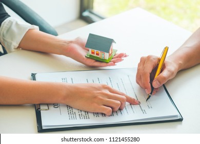 Women Real Estate Agent Showing Where To Sign On Document For Buy House Contract. Home Loan Contract, Real Estate Concept