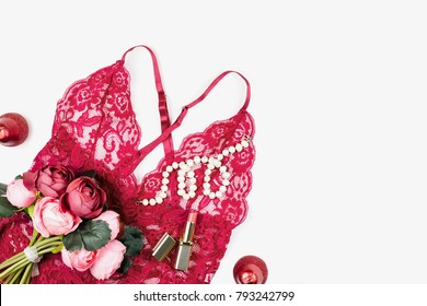 Women red lace lingerie with flowers, make up items on white background. Postcard for Womens Day.
