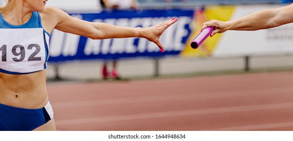 Women Relay Team Passing Of Baton In Track And Field