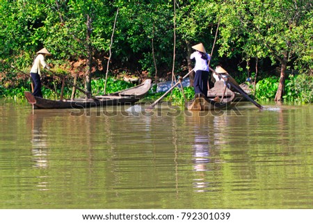 Women rowing on the Mekong river near Ho Chi Minh City, Vietnam.
