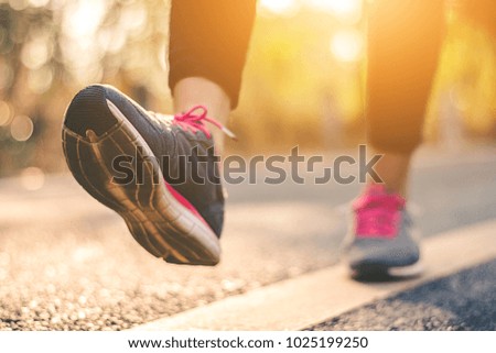 Women runner feet on road in workout wellness concept.