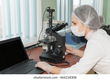 Women Scientists Exploring The Biological Sample By Modern Electron Microscope In A Laboratory