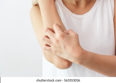 Women scratch the itch with hand / arm  itching / Concept with Healthcare And Medicine.