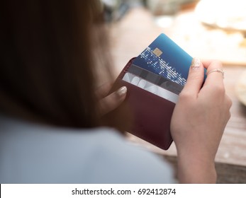 Women Is Selecting Credit Card From Her Card Wallet