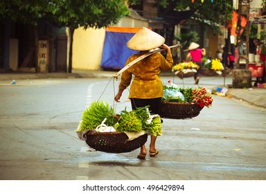Women selling flowers in the early morning in a small market, Hanoi, Vietnam. Life of florist vendor in Hanoi, Vietnam.
