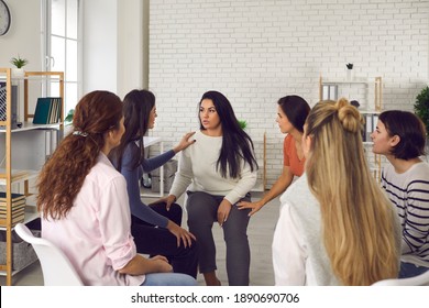 Women sharing their true stories in therapy session or support group meeting. Young friends talking, sharing news, discussing life situations, giving each other advice and helping cope with problems