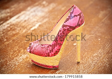 Women shoes pink high heels. Stylized snake skin.