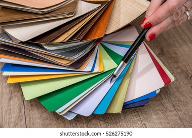 Women Showing Samples Of Laminate And Vinyl Floor Tile