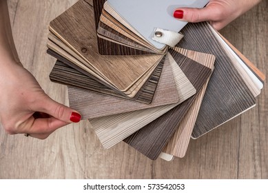 Women Showing Samples Of Laminate And Vinyl Floor Tile