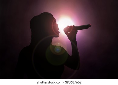  Women Singing Under Spotlight