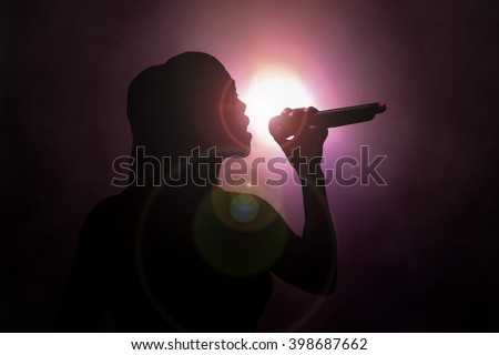 Women singing under spotlight