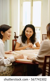 Women Sitting Around Mahjong Table, Talking