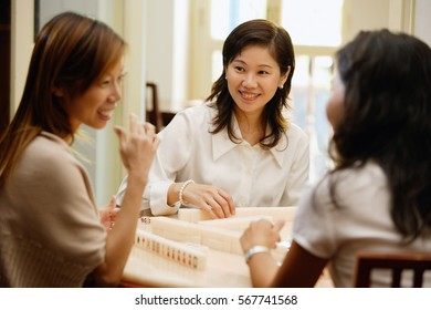 Women Sitting Around Mahjong Table