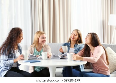 Women Sitting At Table In Book Club