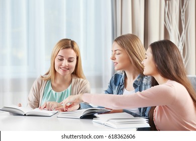 Women Sitting At Table In Book Club