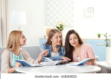 Women Sitting At Table In Book Club