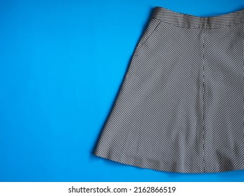 Women Skirt On A Blue Background. Fashion Trends And Current Events. Classic Black And White Women Skirt