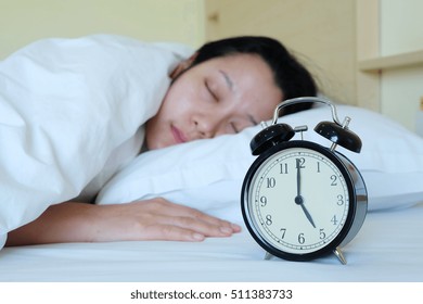 Women sleep with clock