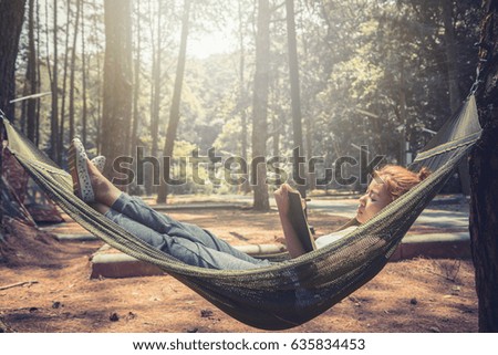 Women sleeping reading. In the hammock. In the natural atmosphere in the park