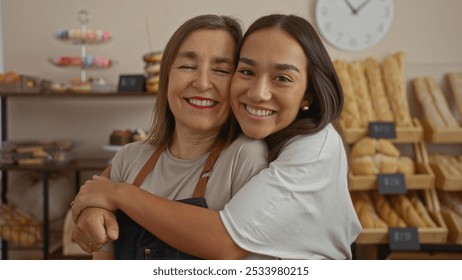 Women smiling together, standing in a bakery with shelves of bread and pastries in the background, suggesting a happy work environment. - Powered by Shutterstock