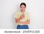 A women smiling when staring at her mobile phone