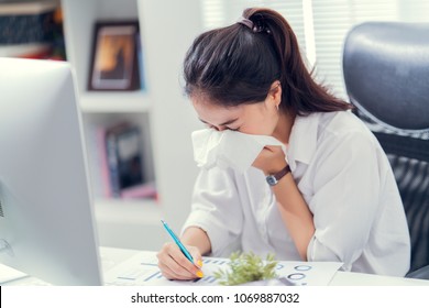 Women Are Sneezing And Are Cold. She Is In The Office.