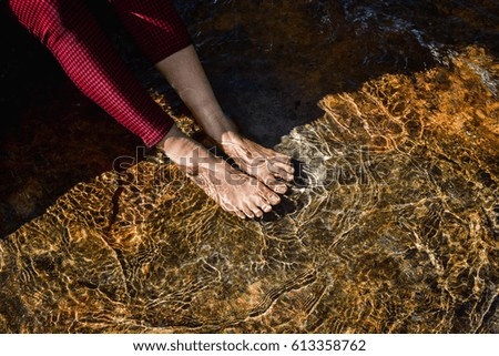 Women soak in natural waterfalls,Thailand