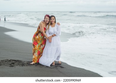 Women Spending Quality Time Together At The Beach. Mother And Daughter Enjoying Quality Time At The Beach. Pacific Ocean, Cloudy Day.