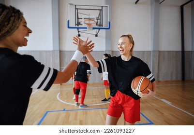 Women, sports team players, in gym celebrating victory. - Powered by Shutterstock