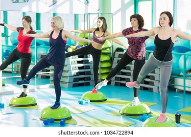 Women Standing On Balance Board