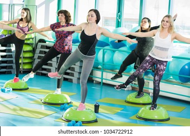 Women Standing On Balance Board