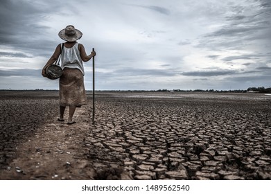 Women Standing On Dry Soil And Fishing Gear, Global Warming And Water Crisis