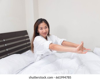 Women are stretched on a bed of white.