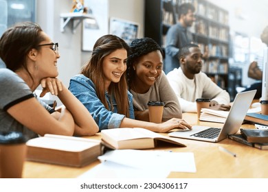 Women, students in library with laptop and studying for exam or research for project with education. Young female people in study group, search internet on pc and learning on university campus - Powered by Shutterstock