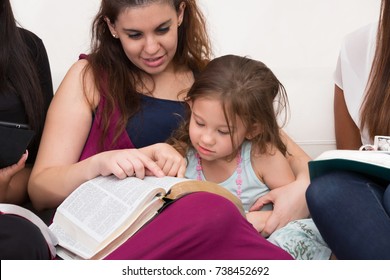 Women Studying The Word Of God With Child