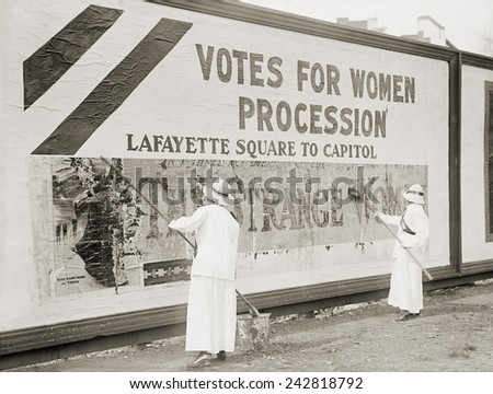 Women suffragists cover a billboard to advertise their Washington, D.C. parade. Nation-wide demonstrations were held in May 1914 to support the Federal Amendment enfranchising women.