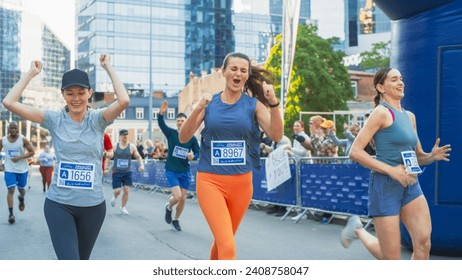 Women Supporting Women: Portrait of Happy Female Runners Participating in a Marathon. Group of Friends Celebrating Together and Congratulating Each Other on Crossing the Finish Line - Powered by Shutterstock