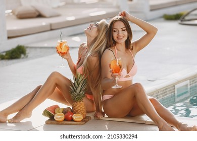 Women in swimsuit resting near the pool - Powered by Shutterstock