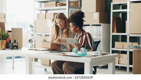 Women, tablet and teamwork for office logistics, package and e commerce checklist with stock of online shop. Small business people or seller with digital tech, box and clipboard for website order - Powered by Shutterstock