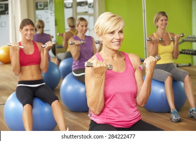 Women Taking Part In Gym Fitness Class