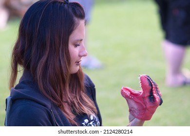 Women Is Talking To A Hand Puppet Dinosaur