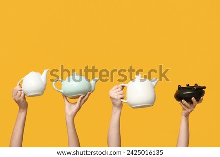 Women with teapots on yellow background