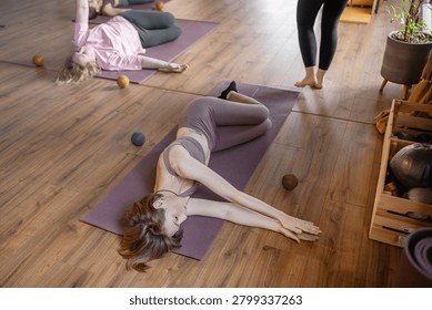 Women three generations doing different yoga exercises lying on back. Women's health of joints and spine