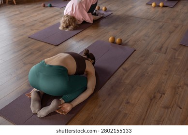 Women three generations doing different yoga exercises lying on back. Women's health of joints and spine