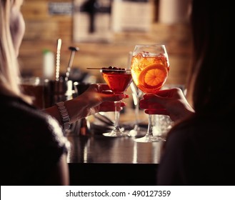 Women Toasting With Cocktails In Bar