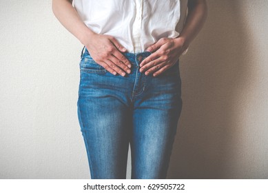 Women touching lower abdomen
