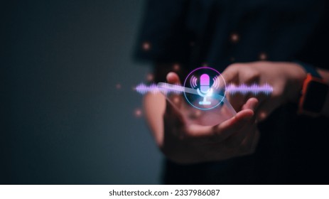 Women touching microphone icon on smartphone. Mobile application Record sound, audio, music, voice message. or Use your voice to direct AI to search for information on Internet. Voice recording.  - Powered by Shutterstock