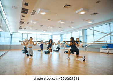 Women train with gymnastic sticks under the supervision of a trainer - Powered by Shutterstock