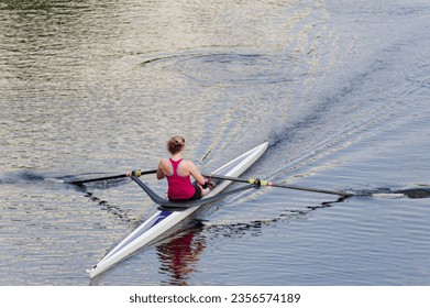 Women training on canoe to practise rowing during early morning on river - Powered by Shutterstock