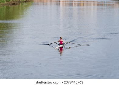 Women training on canoe to practise rowing during early morning on river - Powered by Shutterstock